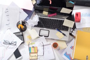 Messy desk and documents all over the place